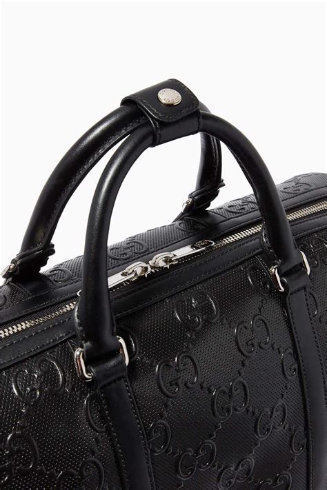 gucci duffle bag black|Gucci embossed duffle bag.